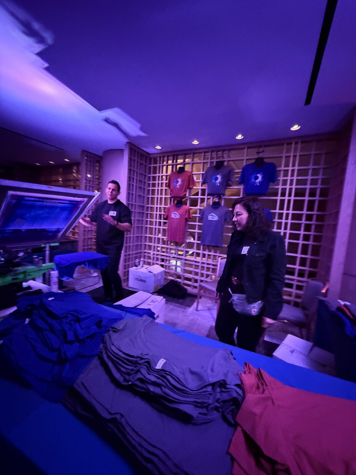 Merch table staged and lit for an evening event