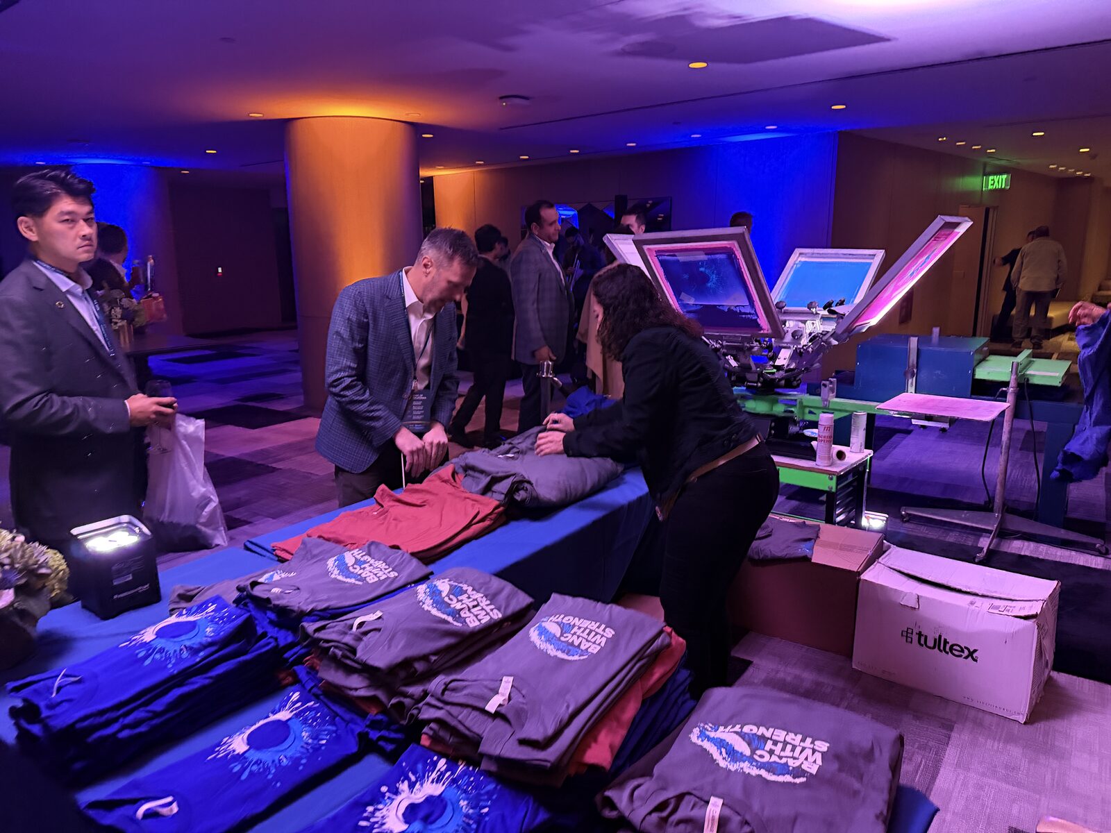 Wide view of a fully built merch table at a formal event